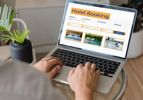 booking online concept, person using laptop computer planning travel search hotel booking.