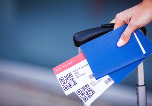 Close up two air ticket in abroad passport near airport